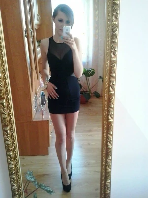 Slime brunette babe in nice tight black mini dress and high heels posing for mirror shot
