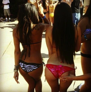 two sluts dancing and showing off their perfect asses at a party