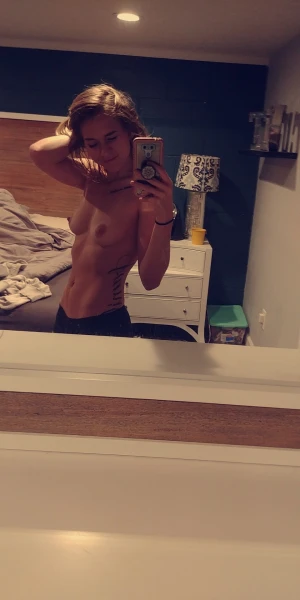 cute fit athletic brunette taking topless selfie